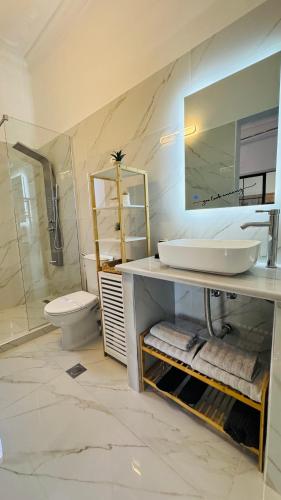 a bathroom with a sink and a toilet and a mirror at Salamina Urban Escape B in Salamina