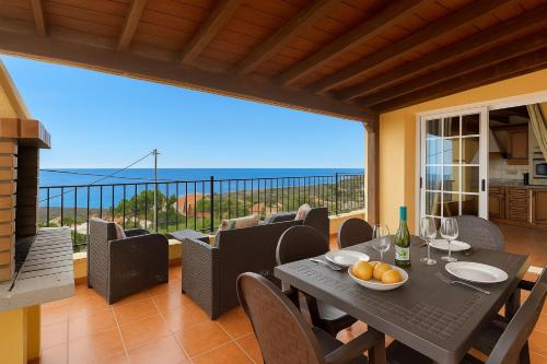 a dining room with a table and a view of the ocean at Casa Rural Tijoco by Paramount Holidays in Adeje