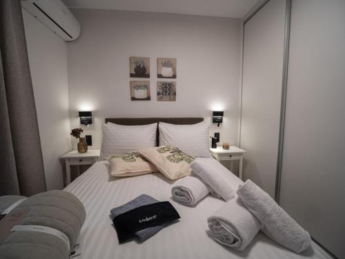 a bedroom with a bed with towels on it at Canva Living in Xanthi