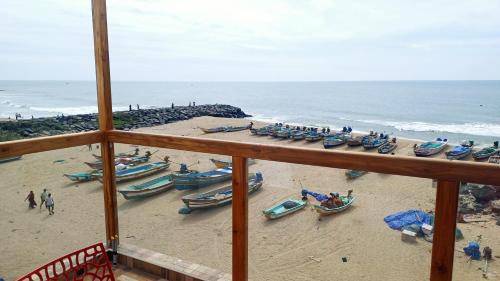 a view of a beach with boats on the sand at Divine Beach Resorts in Puducherry