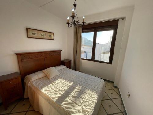 a bedroom with a bed and a window at Juanita La Larga in Doña Mencía