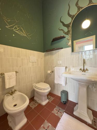 a bathroom with a toilet and a sink at Academia Apulian Suites - Marsia's Apartment in Mola di Bari