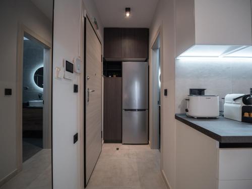 a kitchen with a refrigerator and a counter top at Canva Living in Xanthi