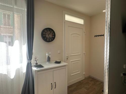 a room with a white door and a clock on the wall at La Loge du Théâtre in Orange