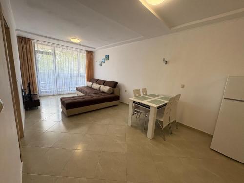 a living room with a couch and a table at Апартаменти Меден Рид in Sozopol