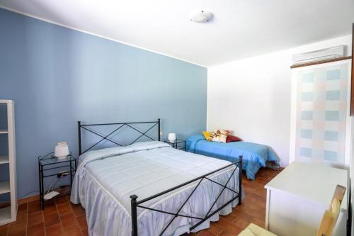 a bedroom with blue walls and a bed and a window at Agriturismo Camera dei ladri in Marsiliana