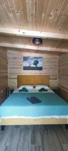 a bedroom with a bed in a wooden room at Trebižat Oasis in Čapljina
