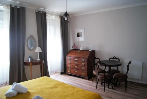 um quarto com uma cama, uma mesa e uma cómoda em O Forte Guest House em Peniche