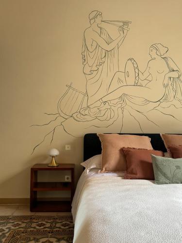 a bedroom with a bed with a mural on the wall at Academia Apulian Suites - Marsia's Apartment in Mola di Bari