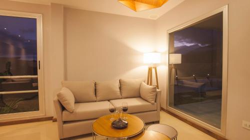 a living room with a couch and a table at Amalinas Hotel in San Lorenzo