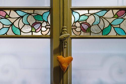two stained glass windows with a heart on a door at Circa 1905 in Barcelona
