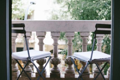 two chairs sitting on a railing on a porch at Circa 1905 in Barcelona