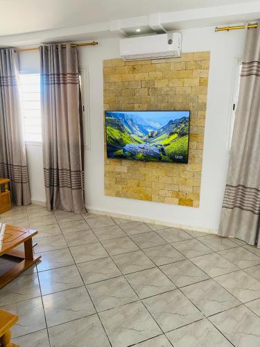 a living room with a painting on a brick wall at Villa Baya in El Haouaria