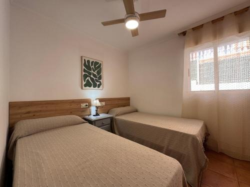 a bedroom with two beds and a window at Nature Somhome Peñíscola in Peñíscola