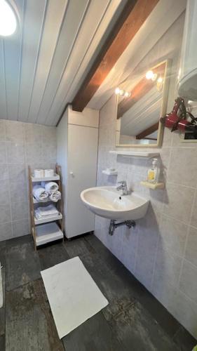 a bathroom with a sink and a mirror at Sepic Apartments in Opatija