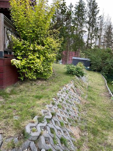 a garden with a stone path next to a house at Eden nad Lubie Linowno in Linowo
