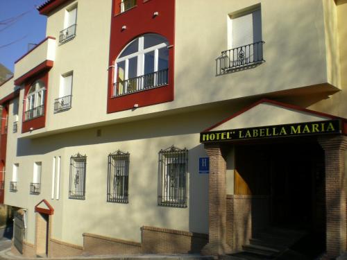a building with a hotelianeiane market sign on it at Labella María in Pinos Genil