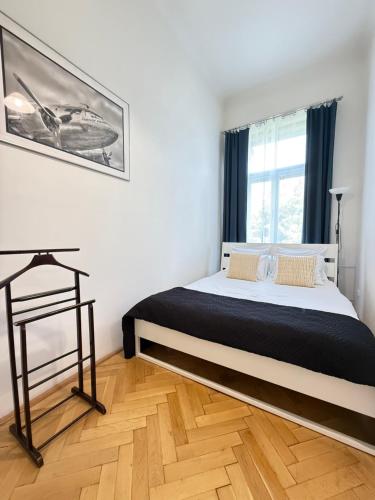a bedroom with a bed and a window at Apartment Hviezdko - Heart of Old Town in Bratislava