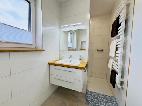a bathroom with a sink and a window at luxuriöse Villa Möwengeflüster - 220qm große Ferienwohnung für bis zu 8 Gästen mit Sauna direkt am Goitzschesee in Pouch