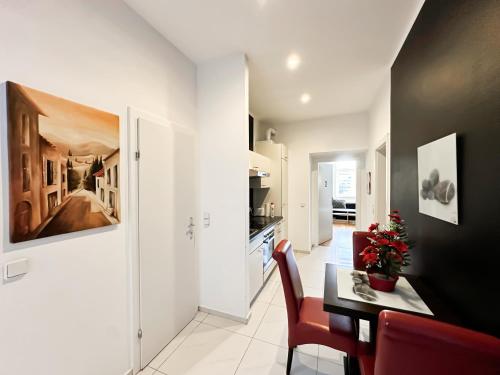 a kitchen with a table and a dining room at Cozy Rooms in Brigittenau Area MM29 in Vienna