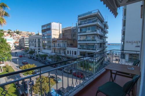 a balcony with a view of a street and buildings at Home Kong in Kavala