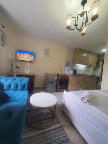 a living room with a blue couch and a table at Regional Homes Ke 1004 in Nairobi