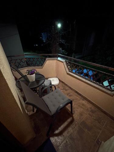 a balcony with a table and chairs at night at Kukunesh Apartments in Ohrid