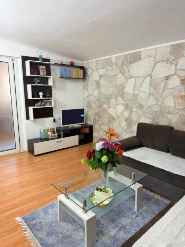 a living room with a couch and a table at ALISA Sea View Apartment Prcanj in Kotor