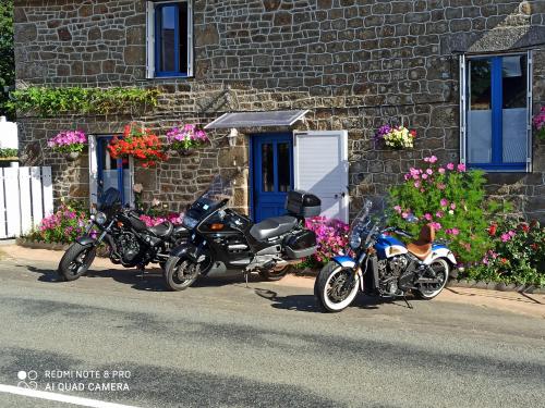 three motorcycles parked in front of a brick building at gîte de LA LANFRAYERE in Saint-Mars-sur-Colmont