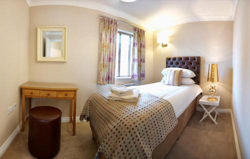 a small bedroom with a bed and a window at Pottergate Apartments 3 bedroom 2 bathroom Central Luxury Apartment in Norwich