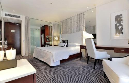 a bedroom with a bed and a desk and a chair at Hotel Goodwill Stay Near Delhi Airport in New Delhi