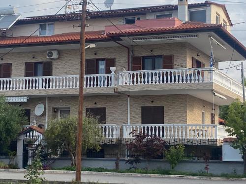 a large house with a balcony on the front of it at Evgenia's Apartment Sozopoli in Sozopoli