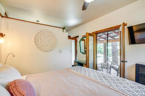 a bedroom with a bed and a sliding glass door at Casita Colibri Lovely, Romantic Patagonia Retreat in Patagonia