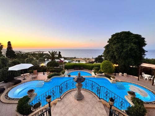 a view of a swimming pool with the ocean in the background at Madliena Hills Mansion in Is-Swieqi