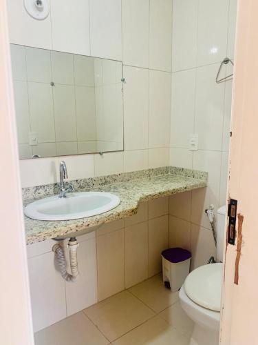 a bathroom with a sink and a toilet at Ap prainha top in Arraial do Cabo