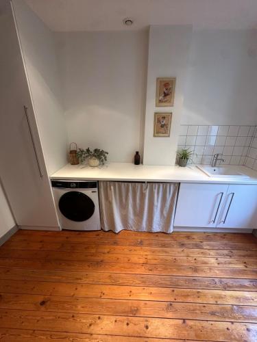 a kitchen with a sink and a stove and a counter at Maison de village avec spa in Barbentane