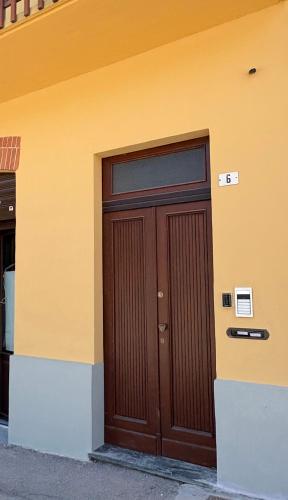 a pair of wooden doors on the side of a building at Vivic Attic Monforte in Monforte dʼAlba