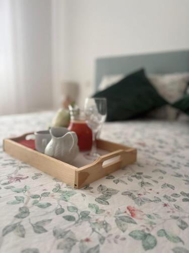 a tray with a tea set on a bed at Apartamento Altamar Portonovo, 100 m playa in Sanxenxo