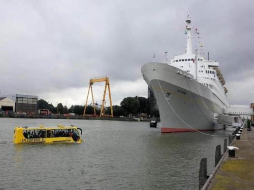 a boat in the water next to a cruise ship at Sun-Soaked Bungalow in Simonshaven in Simonshaven