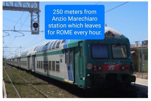 a green and white train on the tracks at ANZIO PARADISE - 350 meters from the station for Rome in Anzio