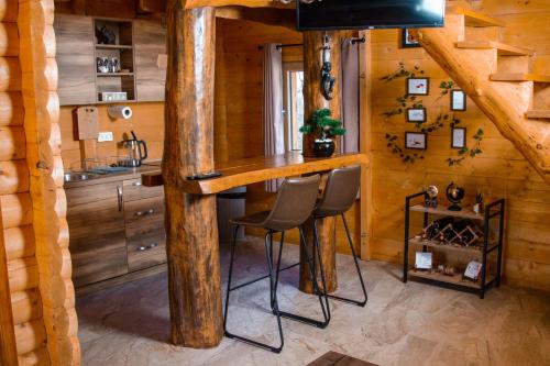 a kitchen with a bar in a log cabin at Green Field Apartments in Virpazar