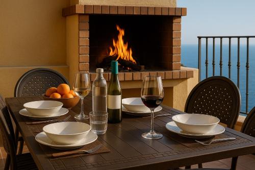 a table with glasses of wine and a fireplace at Casa Rural Tijoco by Paramount Holidays in Adeje