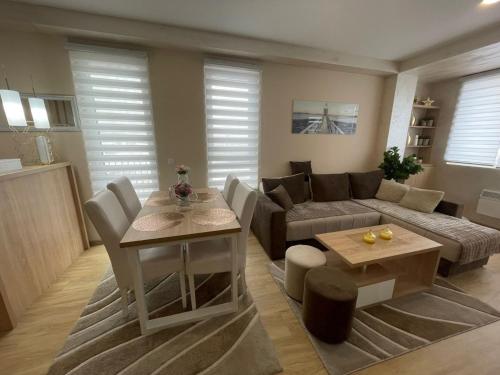a living room with a couch and a table at City centar lux apartman in Zlatibor