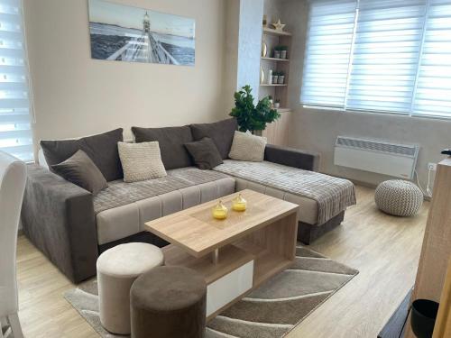 a living room with a couch and a coffee table at City centar lux apartman in Zlatibor