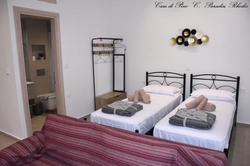 a room with two beds and a couch at Casa di Pino in Paradisi Square near Airport in Paradeísion