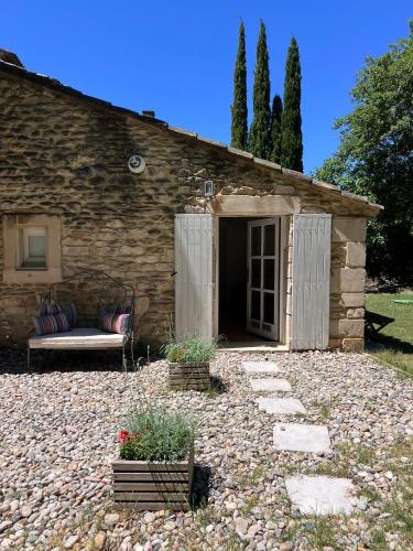 a stone house with a couch in a yard at Le Moulin de Montségur in Montségur-sur-Lauzon
