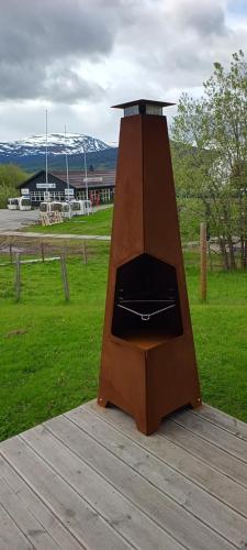 a wooden oven sitting on top of a wooden deck at Ski inn Ski Out Best holiday Apartments i Oppdal in Oppdal