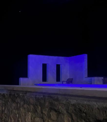 a building lit up in blue at night at Art House Kruje in Krujë