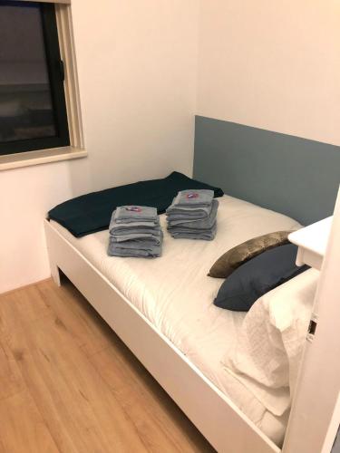 a bedroom with a bed with two towels on it at Vakantiehuis Nynke in Grou