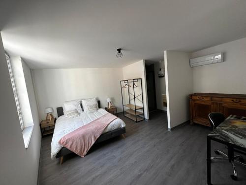 a bedroom with a bed and a dresser in it at 2 pièces parking, plein centre au calme climatisé in Foix